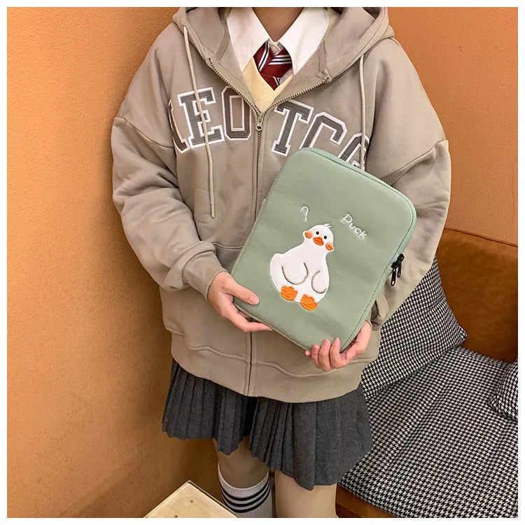 Blue tablet case with embroidered cartoon duck design and a silver zipper closure.