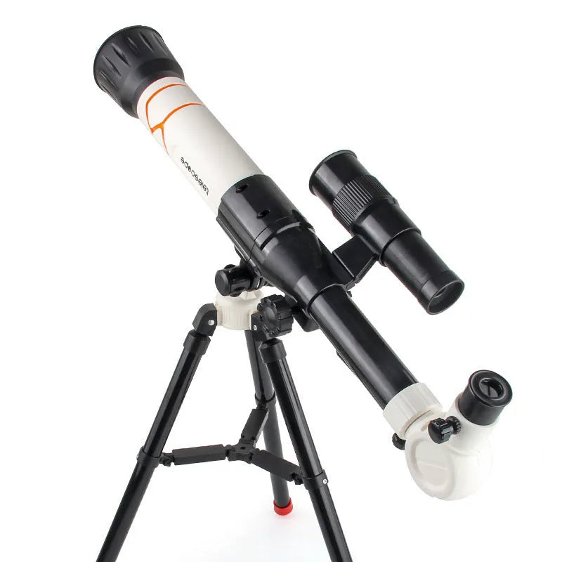 White kids astronomical telescope on tripod with smartphone attached for celestial observation