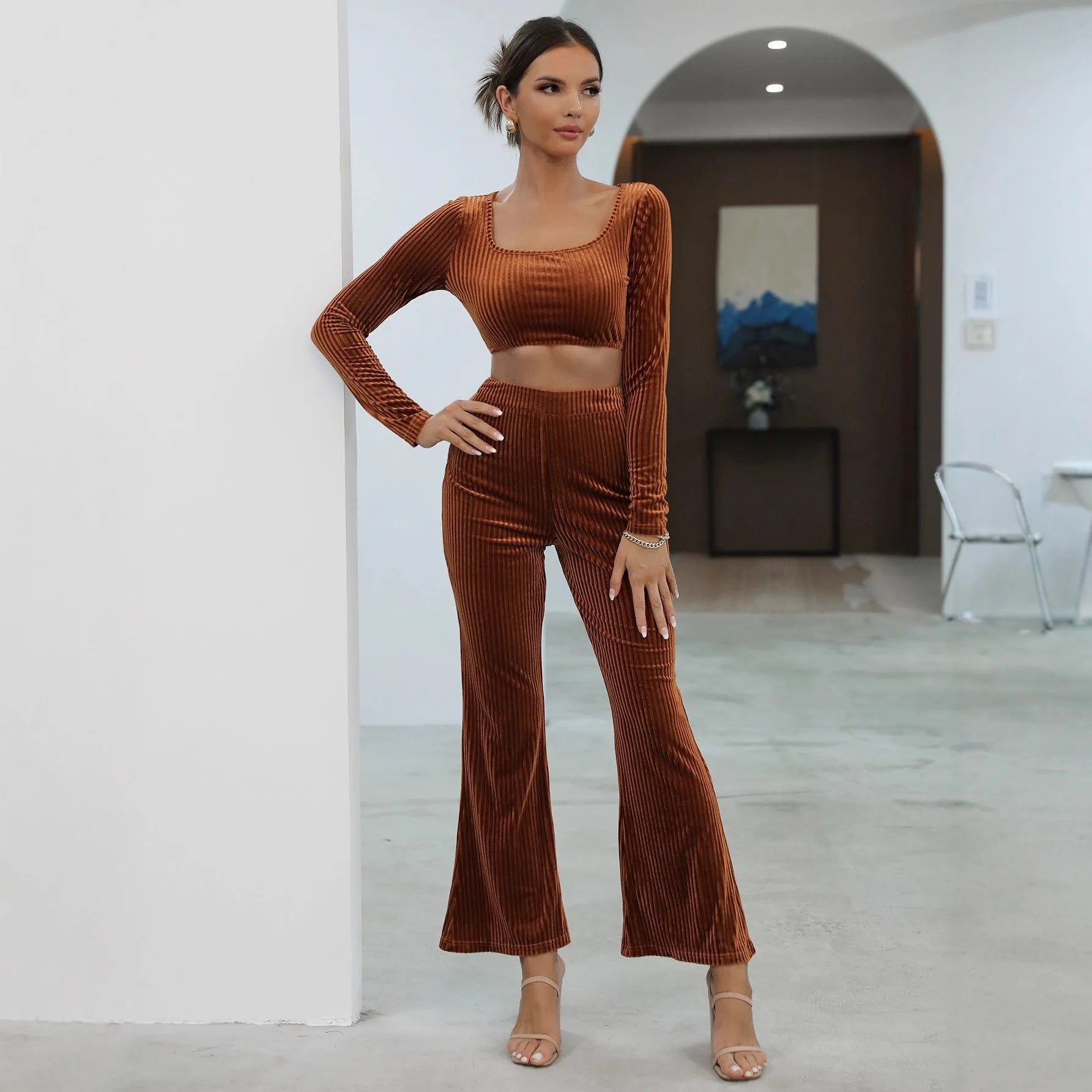 Caramel-coloured women's long sleeve knit sweater and matching trousers laid flat, a two-piece loungewear set.