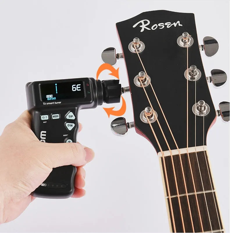 Black and white smart guitar tuner with integrated string winder and colour LCD display on a guitar headstock.
