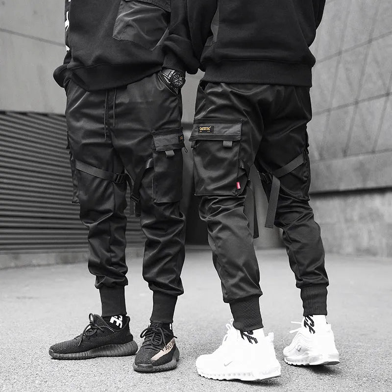 Black 100% cotton overall trousers with tapered leg, front view, on a plain background.
