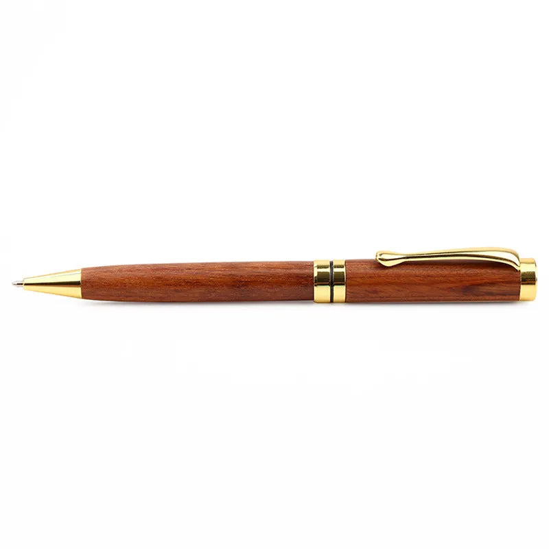 Gold metal and rosewood rollerball pen on a desk, 14cm long