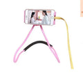 White universal neck phone holder with 360-degree rotating clamp on a table.