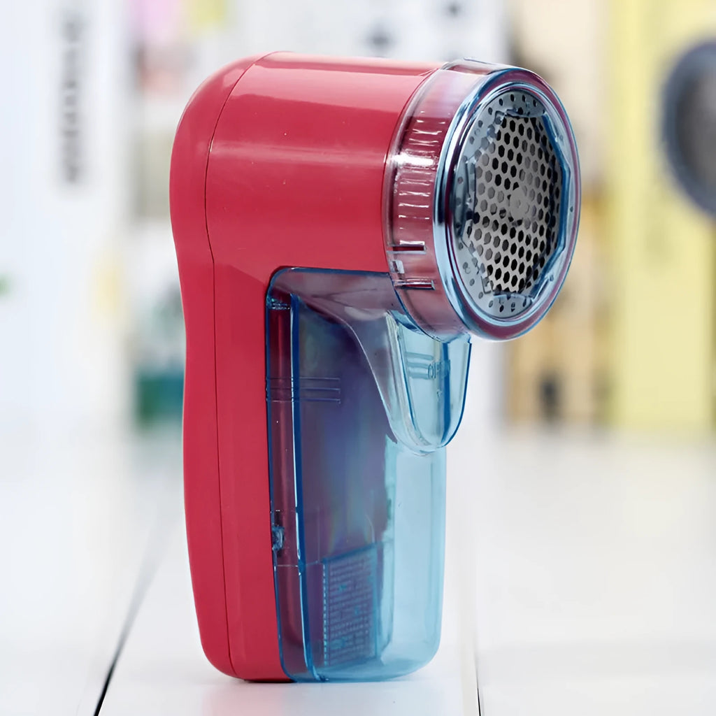 Compact white handheld electric lint remover for clothing, showing fabric shaving head.