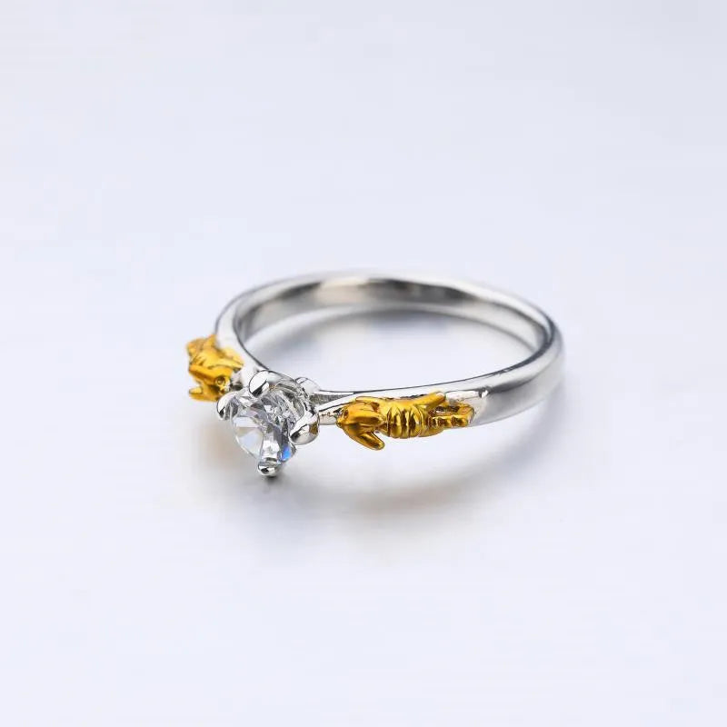 Detailed copper crown ring with crystal accents on a finger, showing black gold and copper finish options.