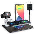 Black desktop wireless charging station with phone on pad, watch and headphone cables plugged in.