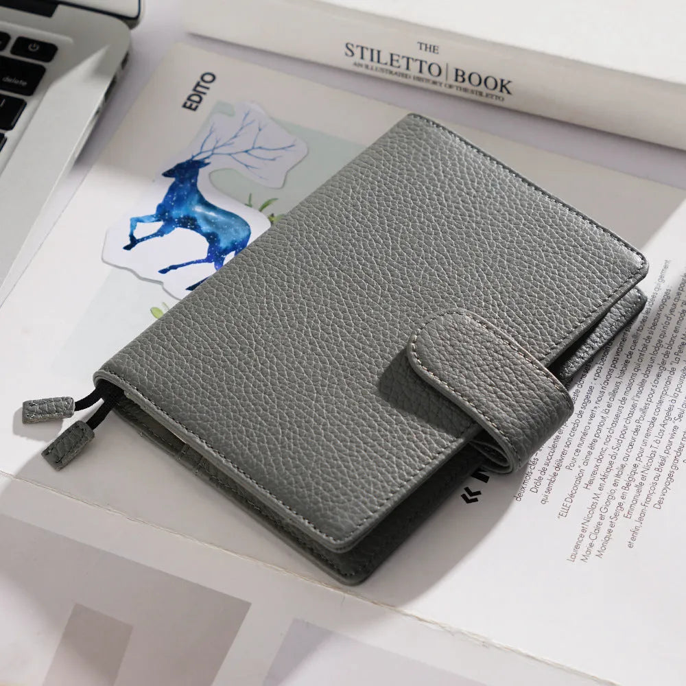A6 leather notebook with lychee pattern cowhide cover showing loose-leaf binding in three colour options