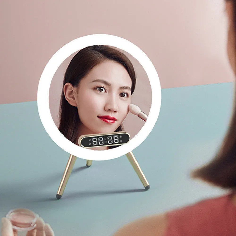 Multi-function LED mirror alarm clock with wireless charger and Bluetooth speaker in white colour on wooden desk