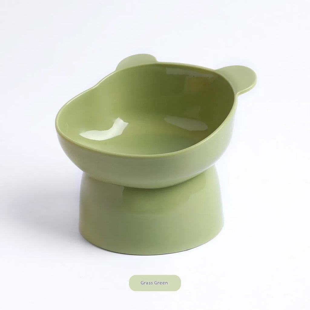 Oblique high foot pet bowl in PP for cats and dogs, shown in one of four colours: rouge pink, deep sea blue, lemon yellow or green grass green.