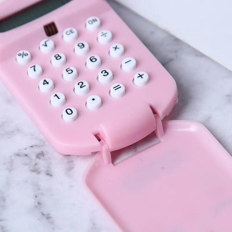 Cookie-shaped mini calculator with key ring in pink, blue, grey, or black, 6.4 x 3.6 x 11.2 cm plastic body