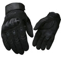 Tactical half-finger gloves with rubber knuckle guards in black colour on a dark background