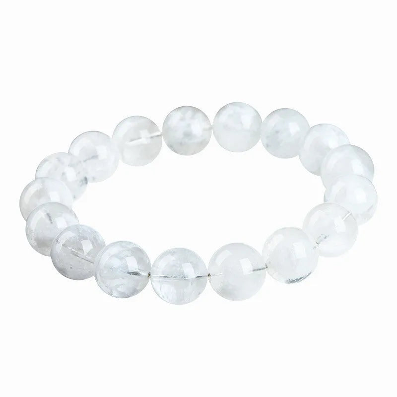 Women's natural blizzard snowflake round bead crystal bracelet with geometric design on a wrist.