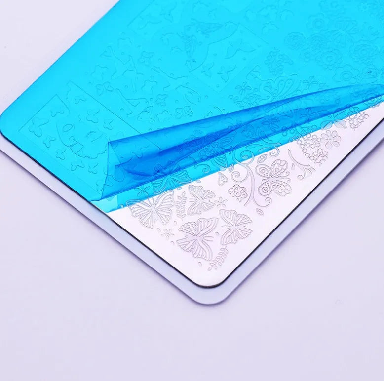 Nail art stamping set with 304 stainless steel plate 12x6cm and white bottom plate on blue protective film