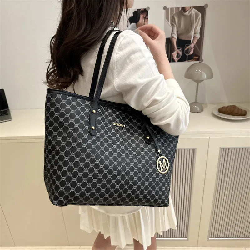 Western style women's shoulder bag in PU leather with contrast stitching, shown in black.