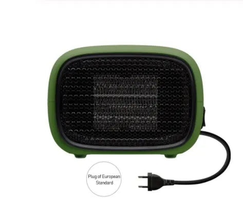 Small green portable ceramic fan heater on a desk showing its compact size.
