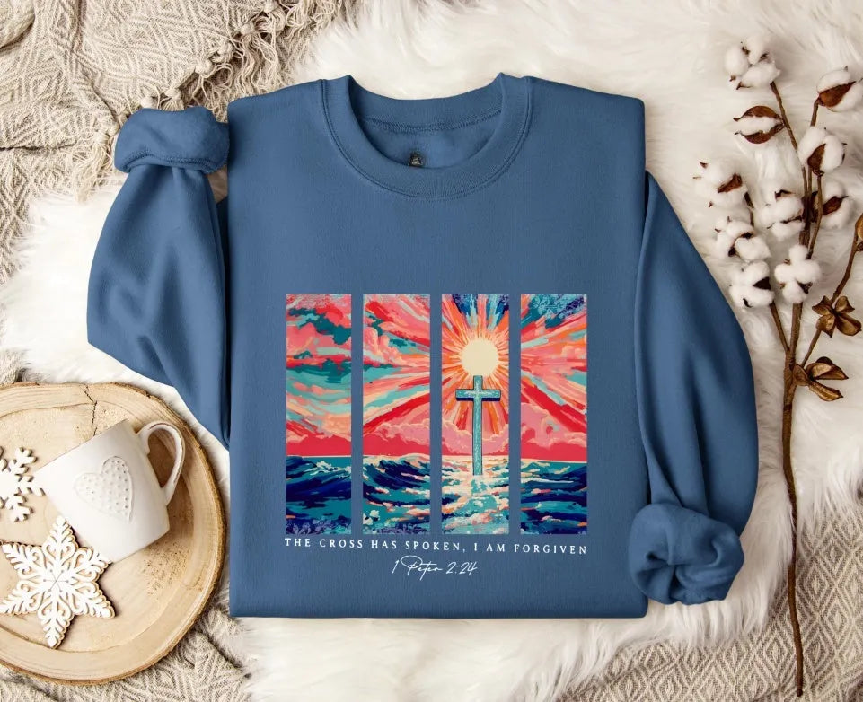 Blue loose-fit women's printed pullover sweater with drop-shoulder sleeves on a hanger.