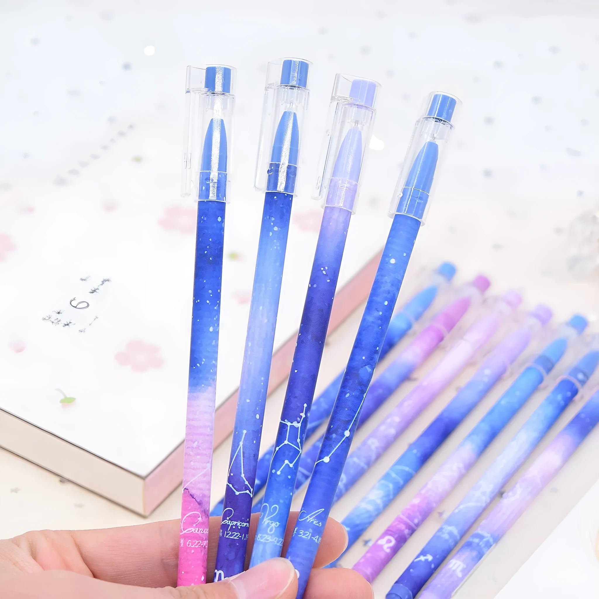 Box containing 12 identical black quick-dry gel pens with constellation branding.