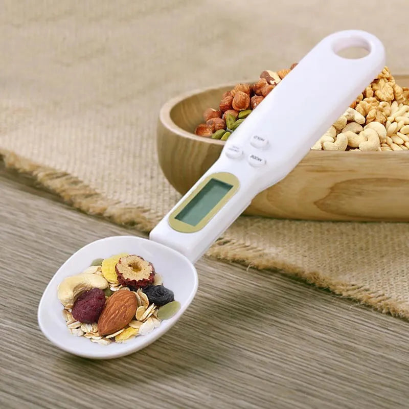 White digital kitchen spoon scale with LCD display showing weight measurement