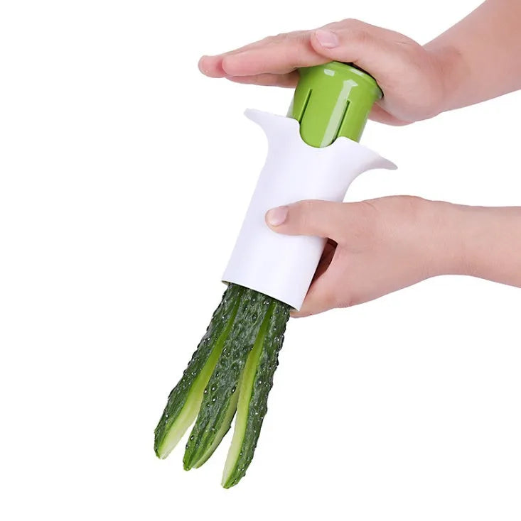 White handheld vegetable cutter with multiple stainless steel blades for slicing cucumbers, carrots, and strawberries.