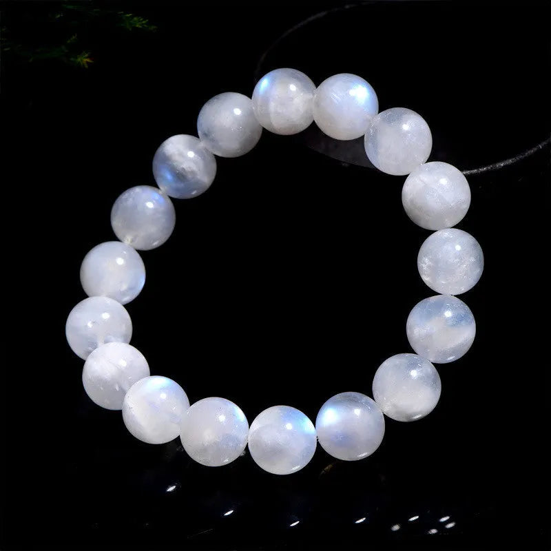 Natural blue and white polished moonstone round bead bracelet on a white background.