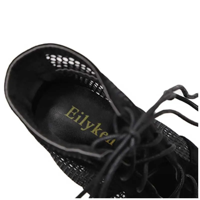 Black suede women's lace-up high heel shoes showing 11.5cm heel and ankle fastening