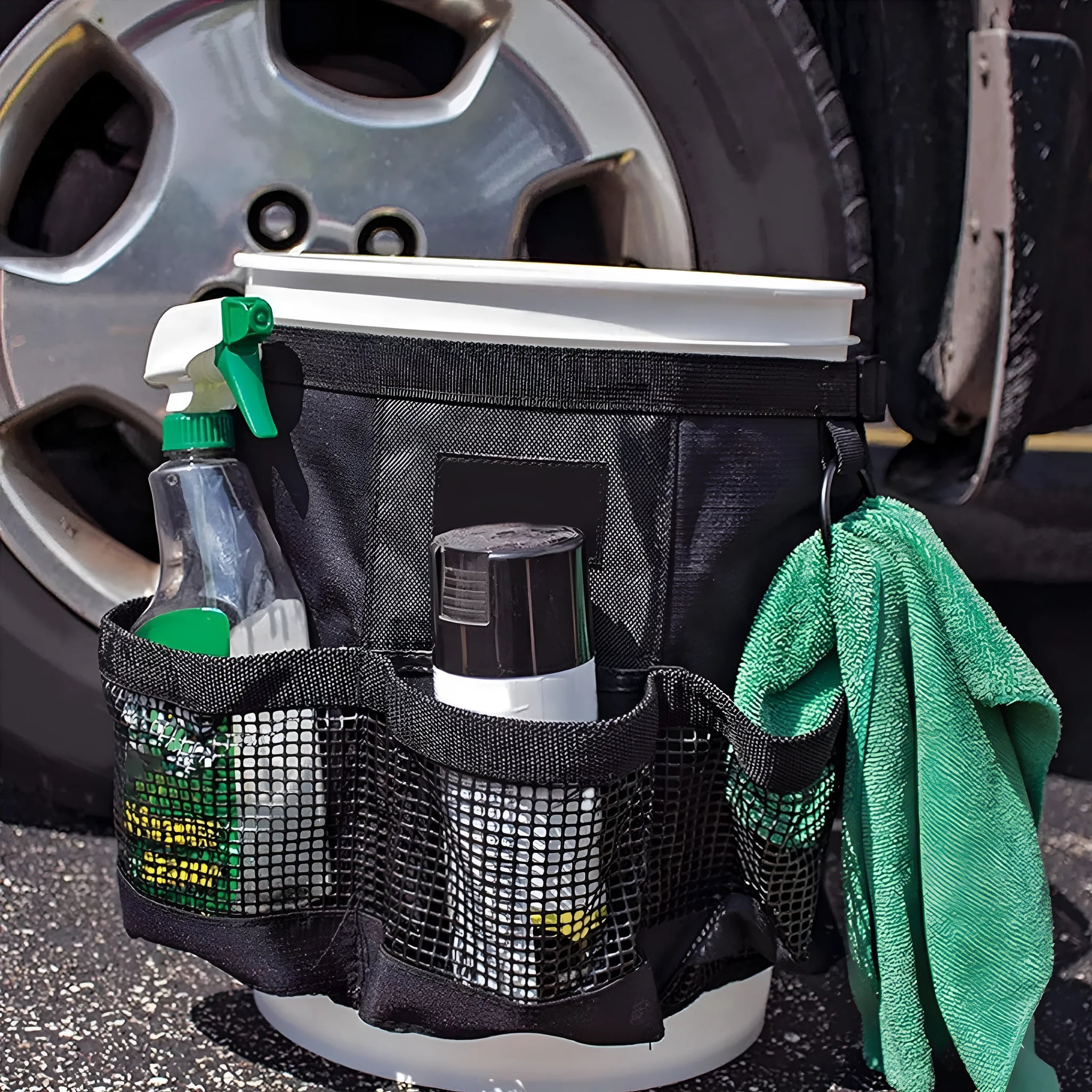 Black cylindrical polyester storage bag hanging on 5 gallon bucket for tool organisation