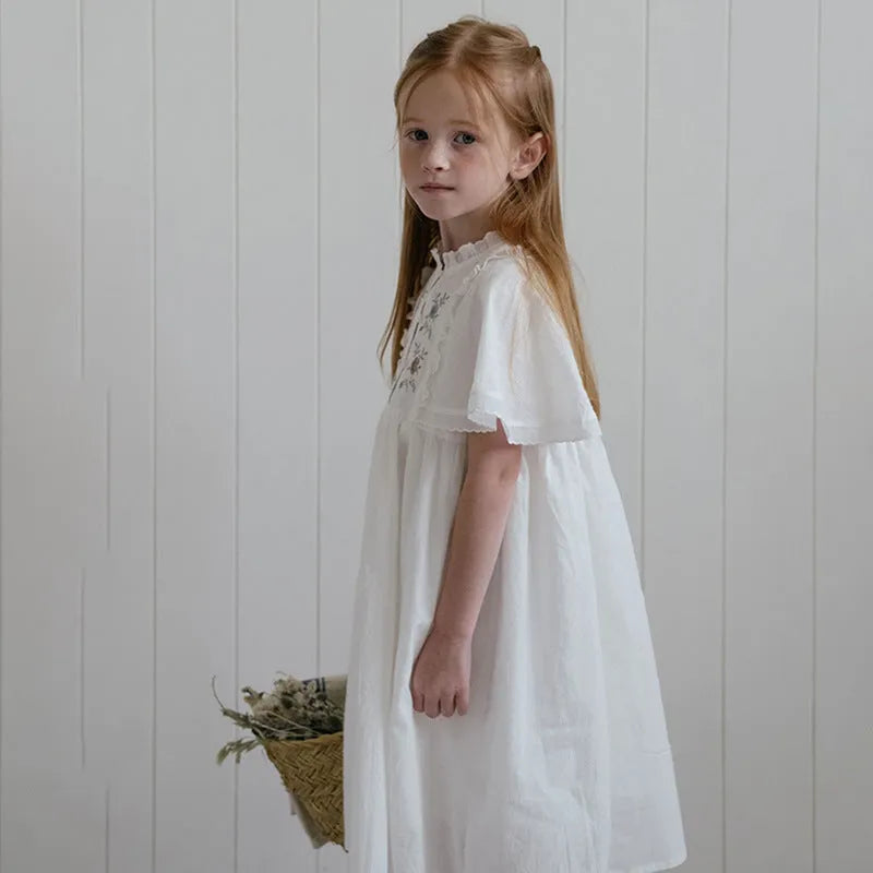 White cotton girls dress with embroidered ruffles, short sleeves, solid colour A-line shape