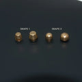 Brass decorative buckle with set of round and bucket-shaped brass foot nails on a surface.