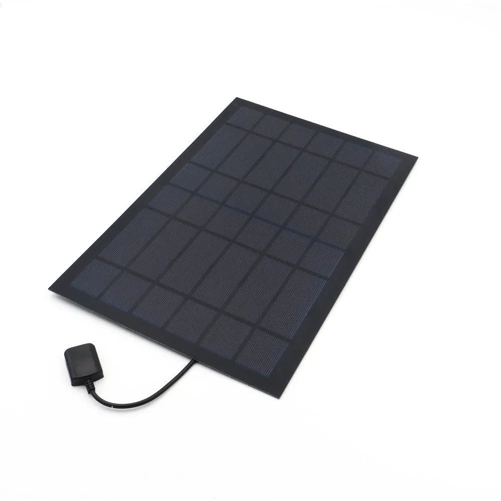 Portable solar panel unit with a small fan and a USB charging port for mobile phones.