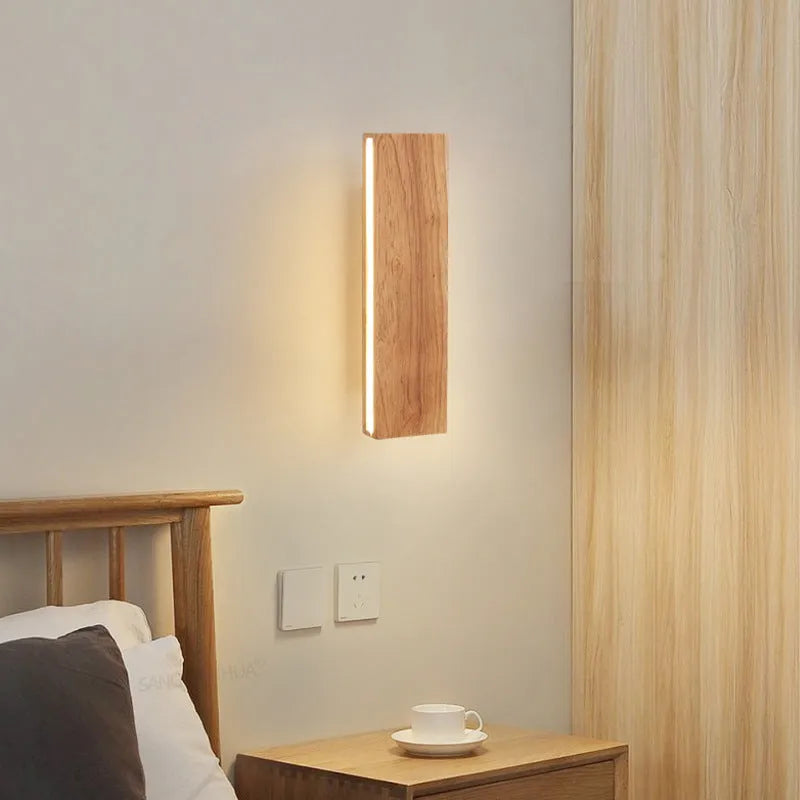 Solid wood Nordic Japanese style LED wall lamp with warm light, 32cm size, mounted above a wooden bedside table