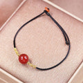 A natural red agate bead bracelet and necklace set with hand-woven detailing.