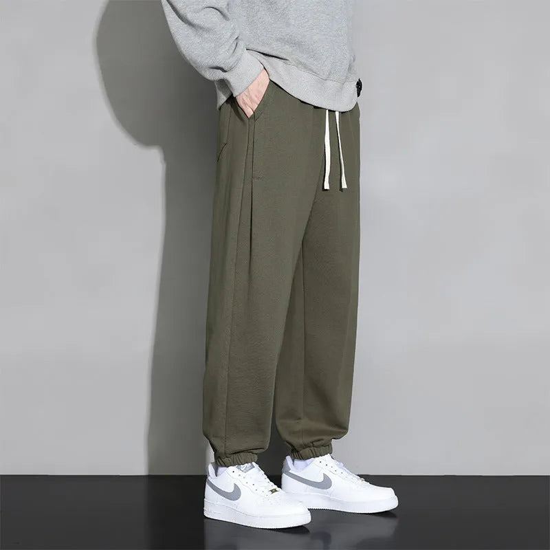 Men's loose grey sports trousers with drawstring waist in cotton-polyester blend