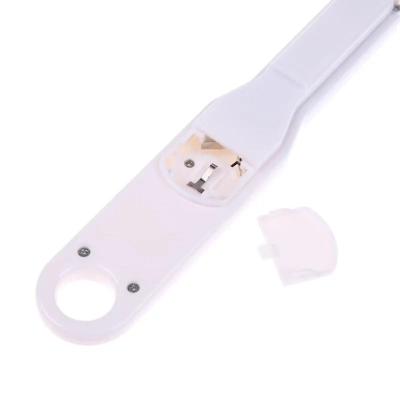 White digital kitchen spoon scale with LCD display showing weight measurement