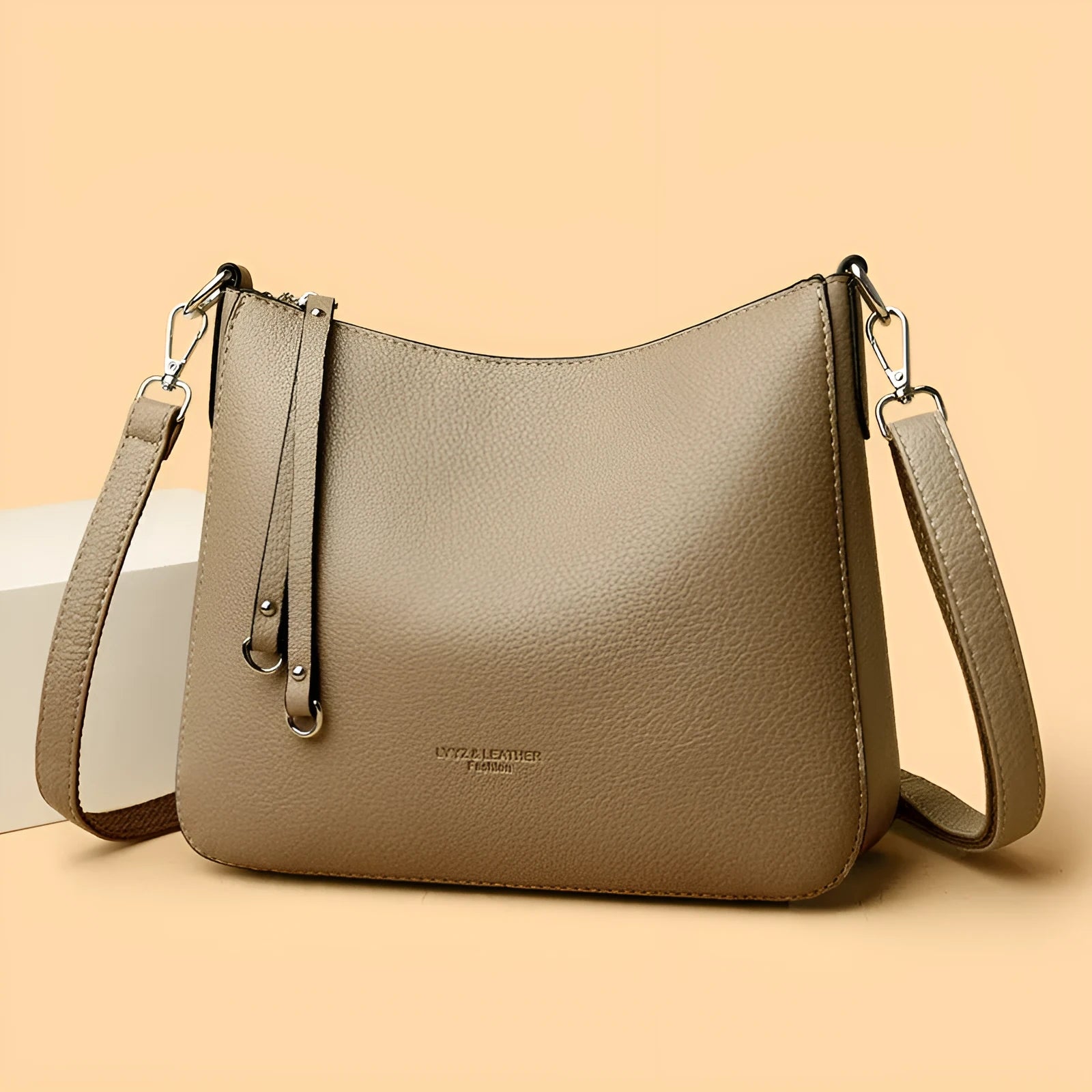 Genuine leather horizontal square shoulder crossbody bag with metal belt detail in beige colour