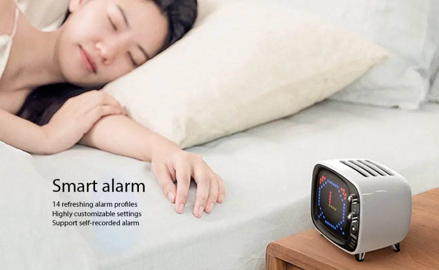 Compact rectangular Bluetooth speaker alarm clock with LED digital display showing time, in various colours.