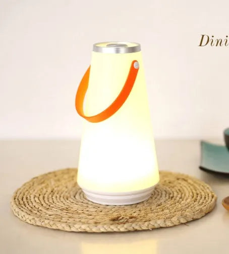 White rechargeable LED night light with touch controls measuring 12x12x22cm