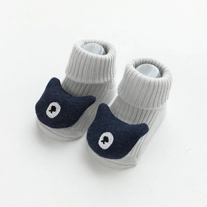 Pair of light grey baby socks with white non-slip silicone grip dots on the soles.