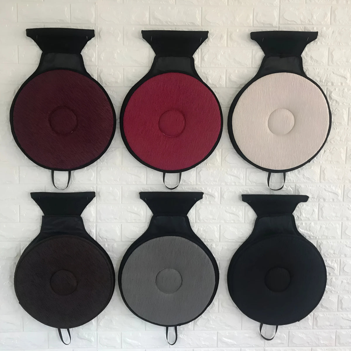 360-degree rotation cushion made of pleated cloth and EVA foam, available in multiple colours, on a chair