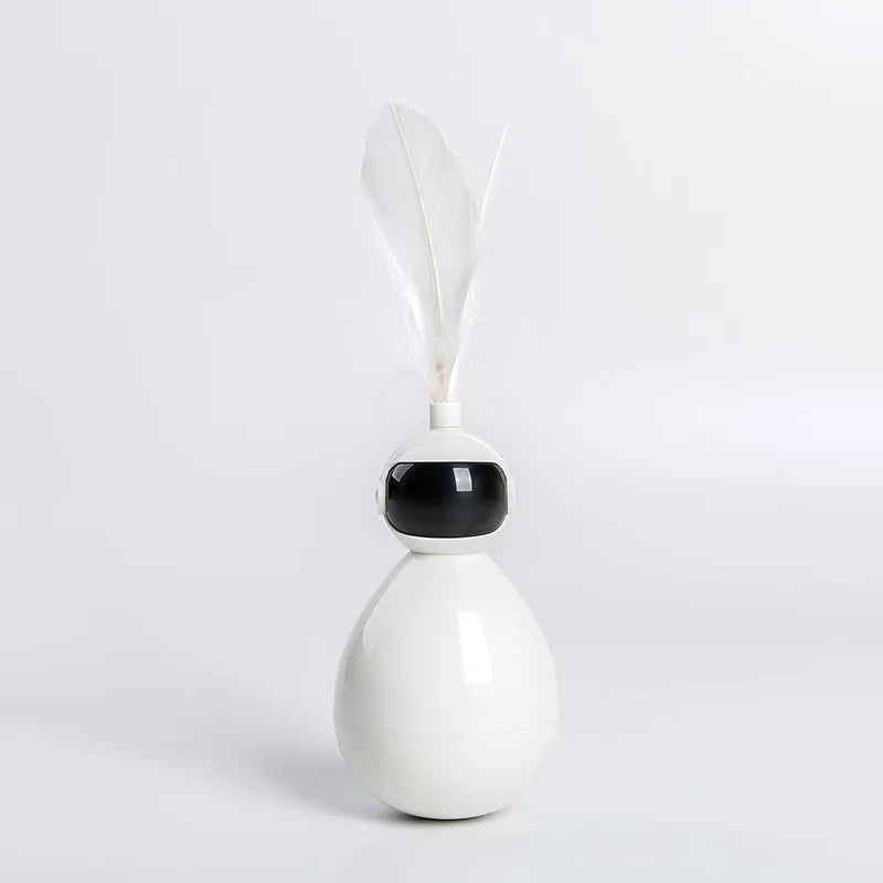 ABS tumbler cat toy with feather attachment in white colour, on a flat surface