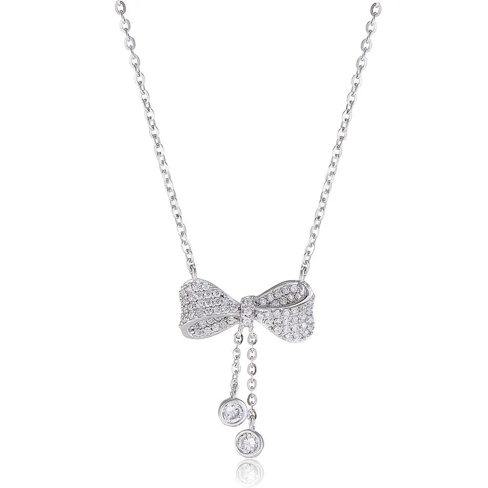 S925 sterling silver bow necklace on collarbone, showing O-ring chain and detailed bow pendant