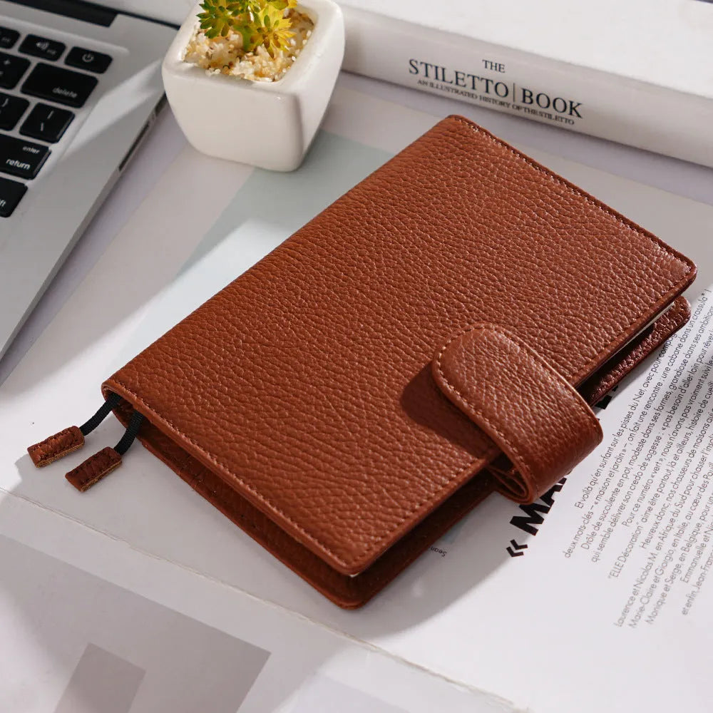 A6 leather notebook with lychee pattern cowhide cover showing loose-leaf binding in three colour options