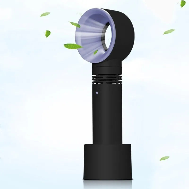 A compact portable bladeless fan with USB cable on a desk.