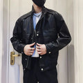 Man wearing a black Korean-style PU leather pilot jacket with a straight hem and side seam pockets.