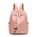 A black soft nylon women's casual travel backpack with double straps and multiple internal compartments.