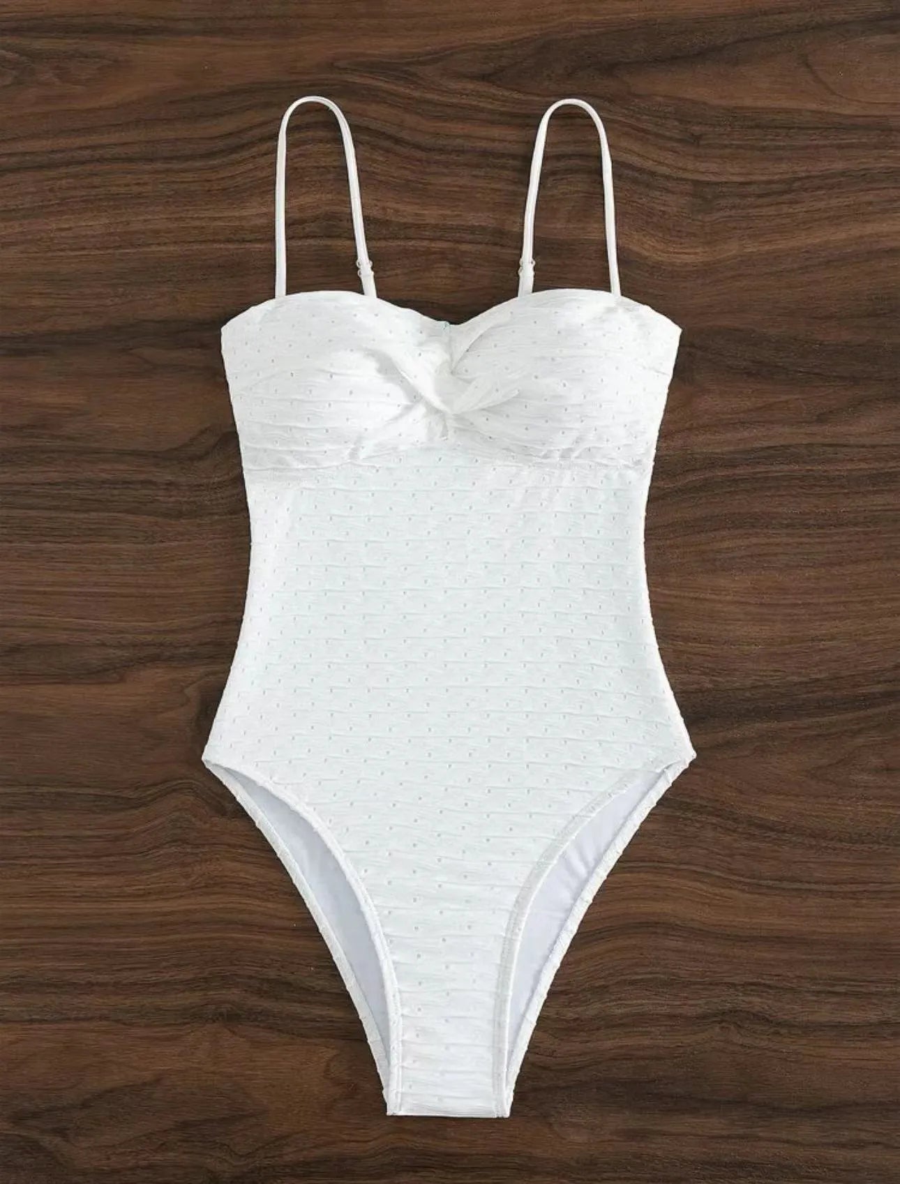 White sling-style one-piece swimsuit for women on a mannequin