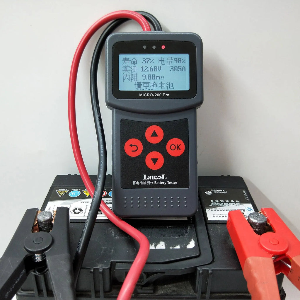 Black car battery tester with display and cables, measuring 15x6x3 cm