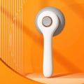 Blue and white self-cleaning slicker brush for grooming cats and dogs on a neutral background.