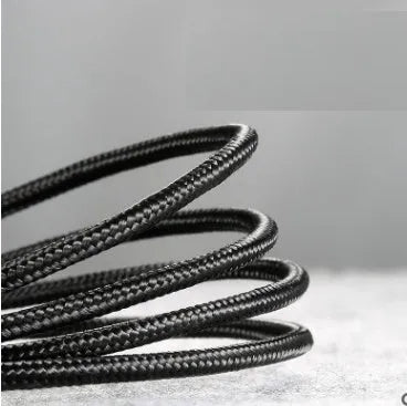 Grey and black woven nylon Android micro USB charging cable shown coiled with connector visible