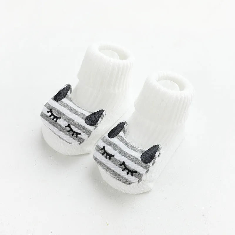 Pair of light grey baby socks with white non-slip silicone grip dots on the soles.