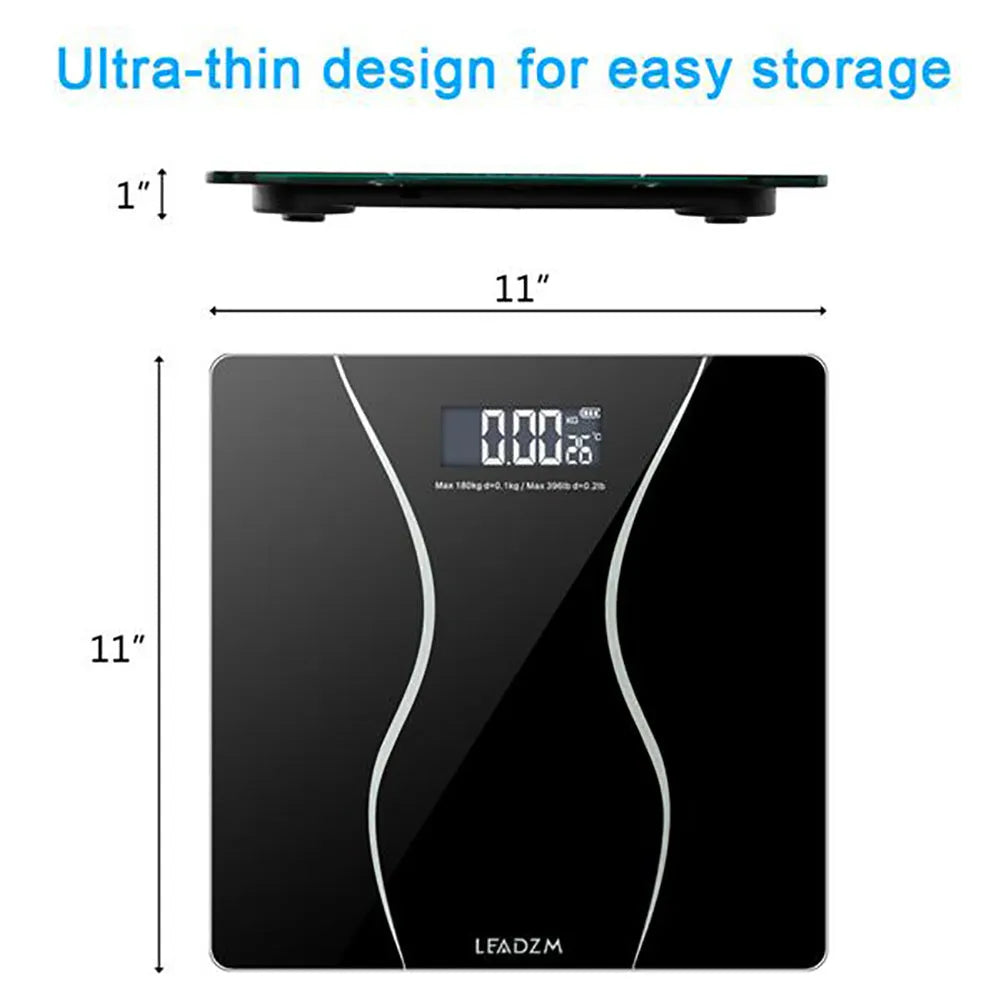 Black digital electronic bathroom scale with tempered glass platform on a bathroom floor.